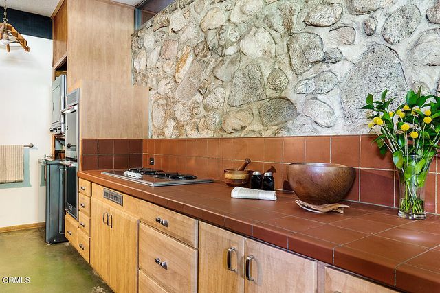 a kitchen with a stove and cabinets