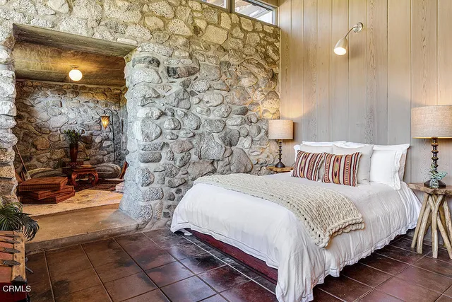 a bedroom with a bed and a mirror