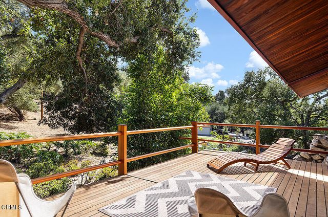 a view of balcony with furniture and trees