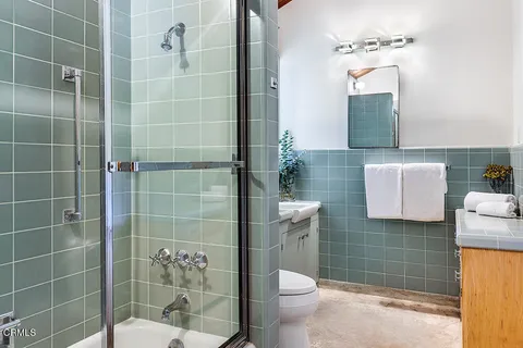 a bathroom with a toilet sink and shower