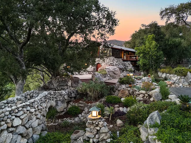 a view of a house with backyard and sitting area