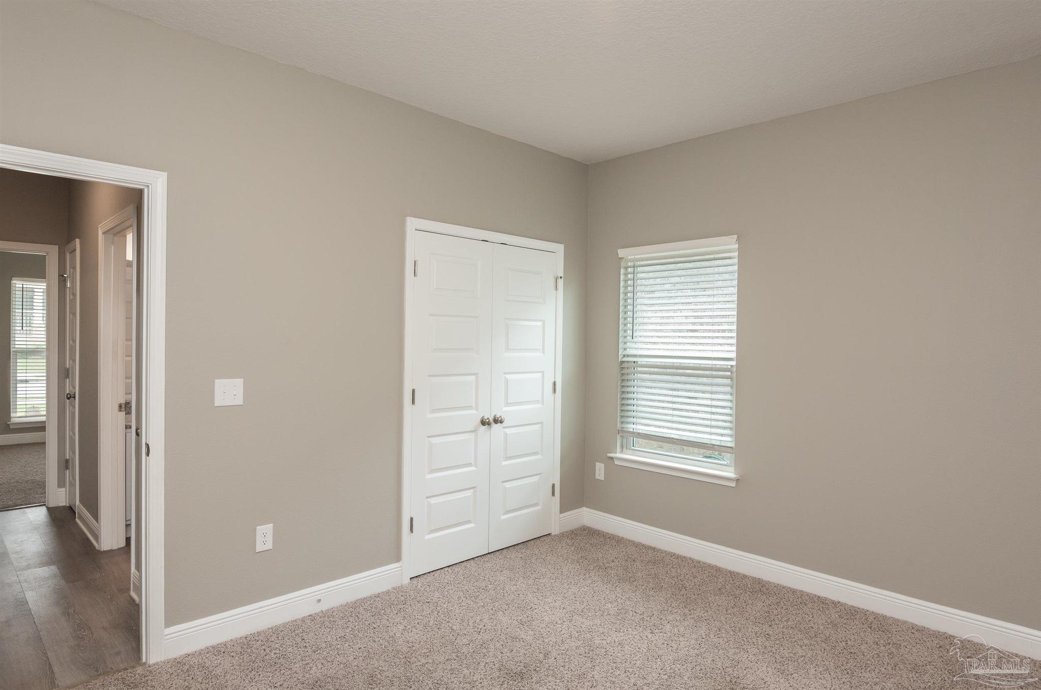 7882 Burnside Loop Pensacola, FL 32526 - Photo 17 of 28 an empty room with windows and closet