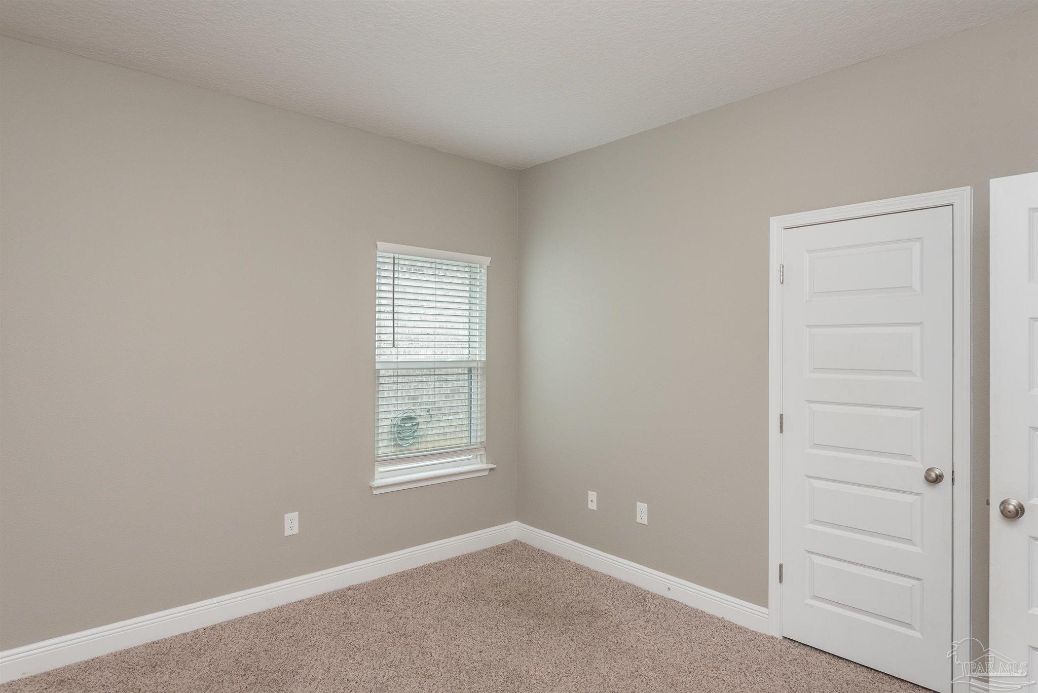 7882 Burnside Loop Pensacola, FL 32526 - Photo 18 of 28 an empty room with windows and closet