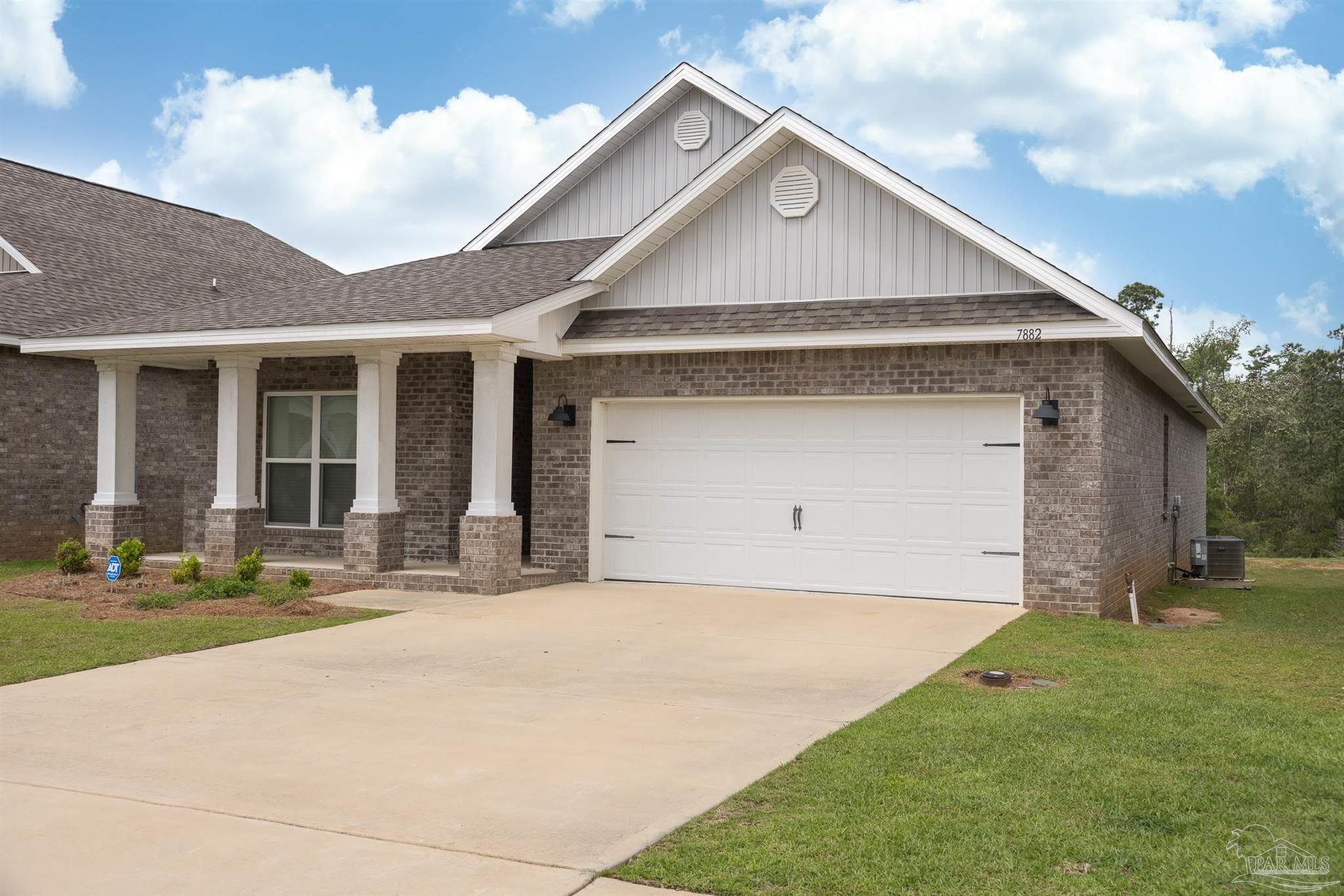 7882 Burnside Loop Pensacola, FL 32526 - Photo 2 of 28 a front view of a house with a yard and garage
