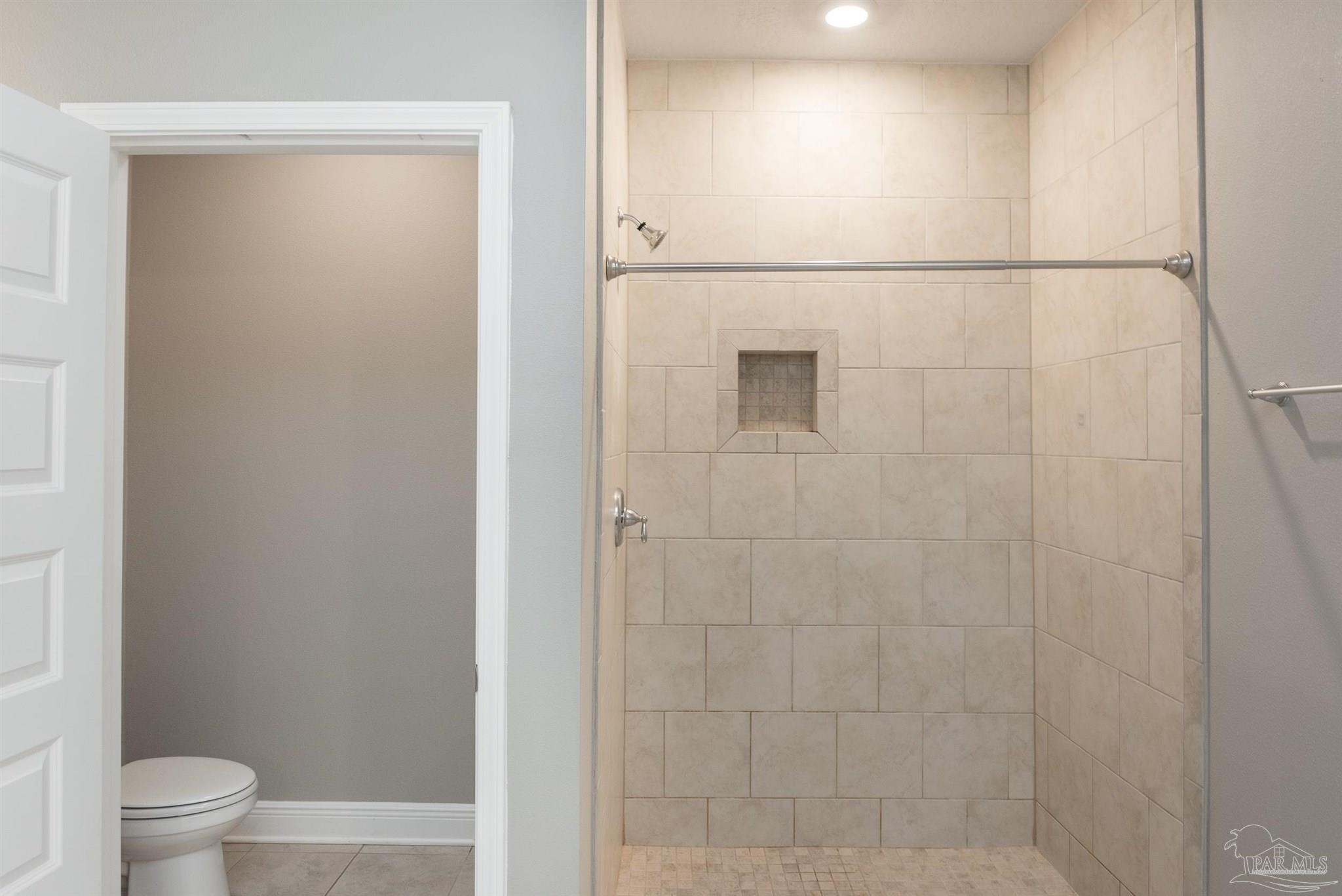 7882 Burnside Loop Pensacola, FL 32526 - Photo 23 of 28 a bathroom with a granite countertop sink a toilet and shower