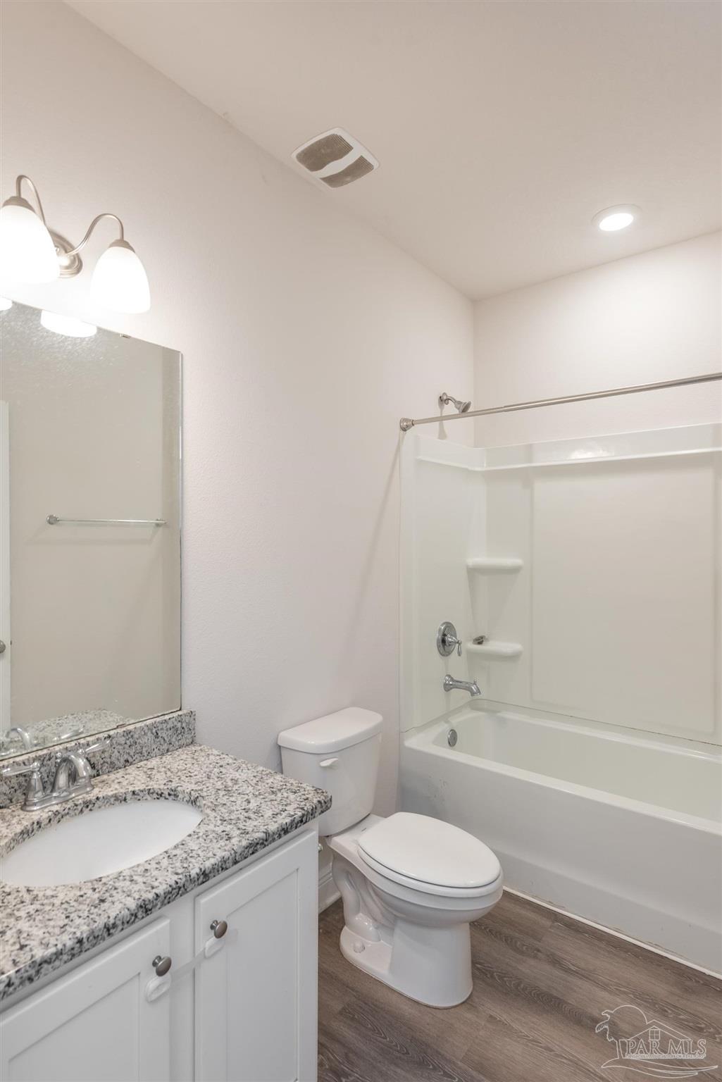 7882 Burnside Loop Pensacola, FL 32526 - Photo 26 of 28 a bathroom with a granite countertop sink a toilet and shower