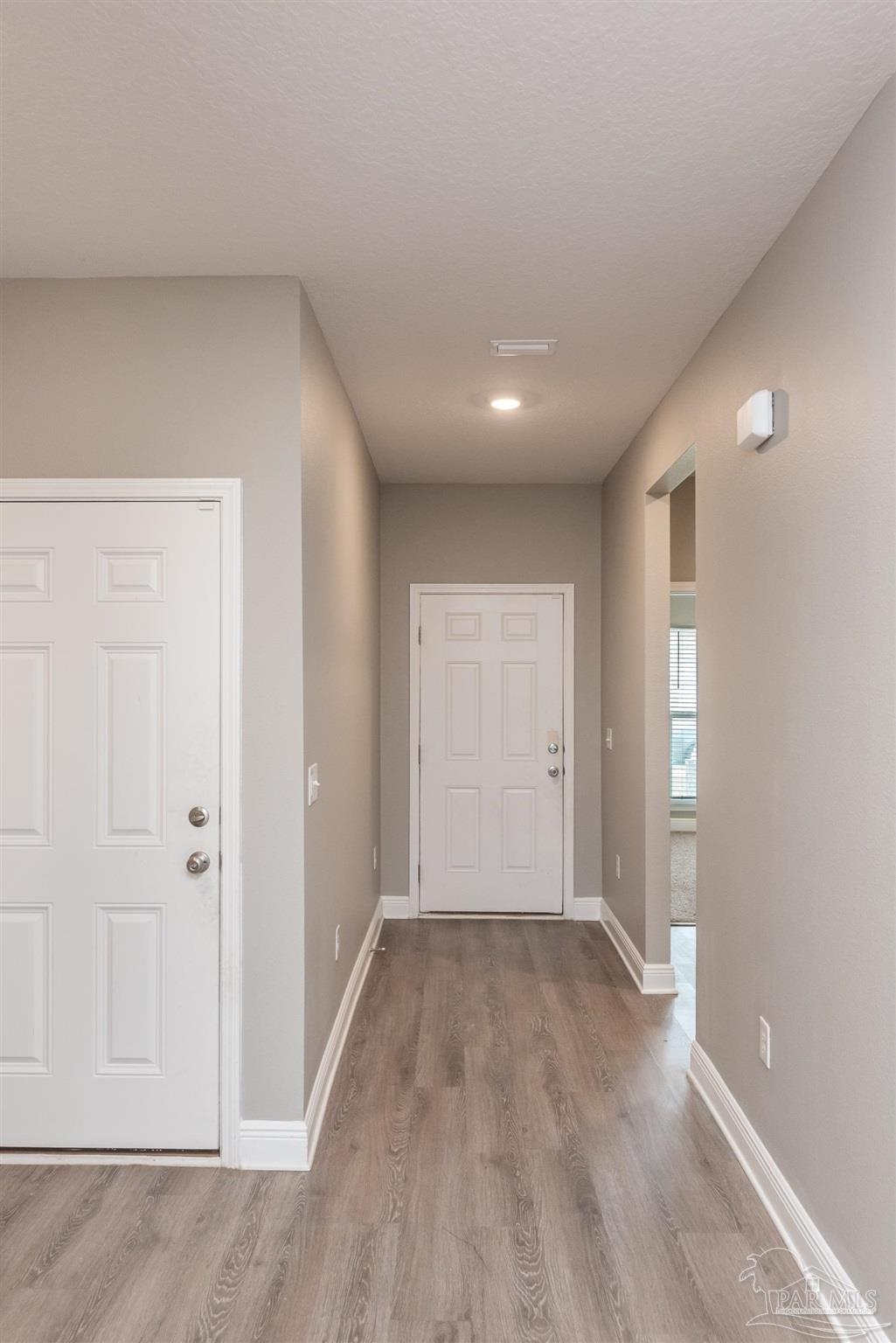 7882 Burnside Loop Pensacola, FL 32526 - Photo 9 of 28 an empty room with wooden floor and windows