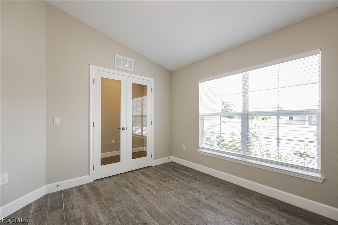 2900 7th Street West Lehigh Acres, FL 33971 - Photo 11 of 15 an empty room with wooden floor and windows