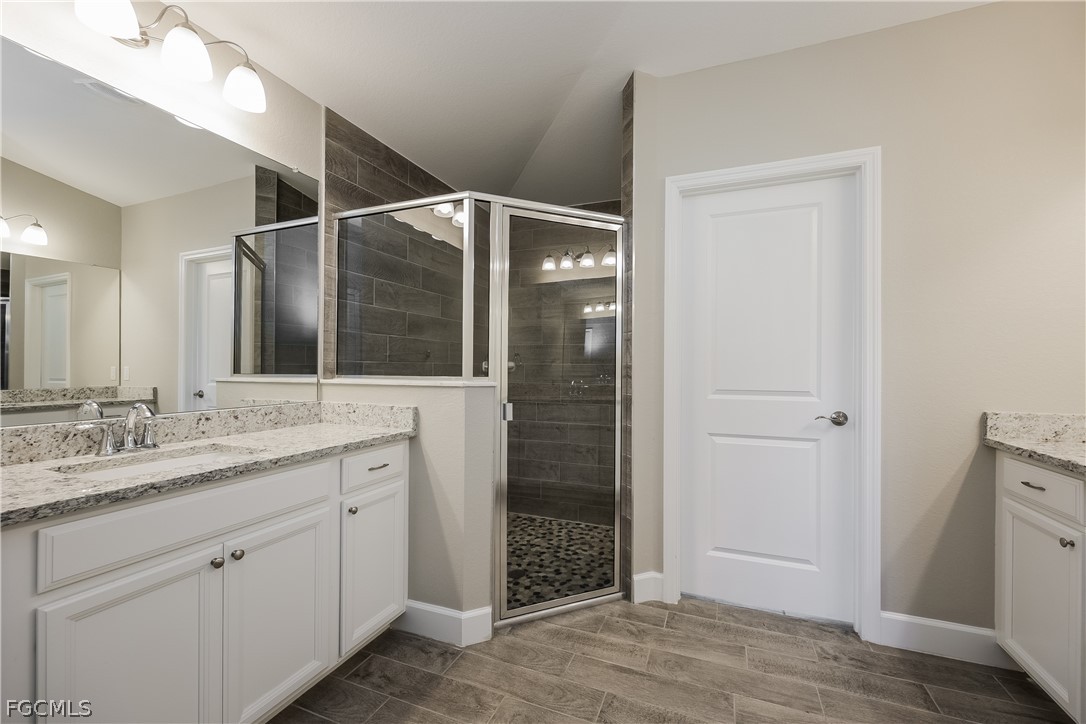 2900 7th Street West Lehigh Acres, FL 33971 - Photo 12 of 15 a bathroom with a double vanity sink and mirror