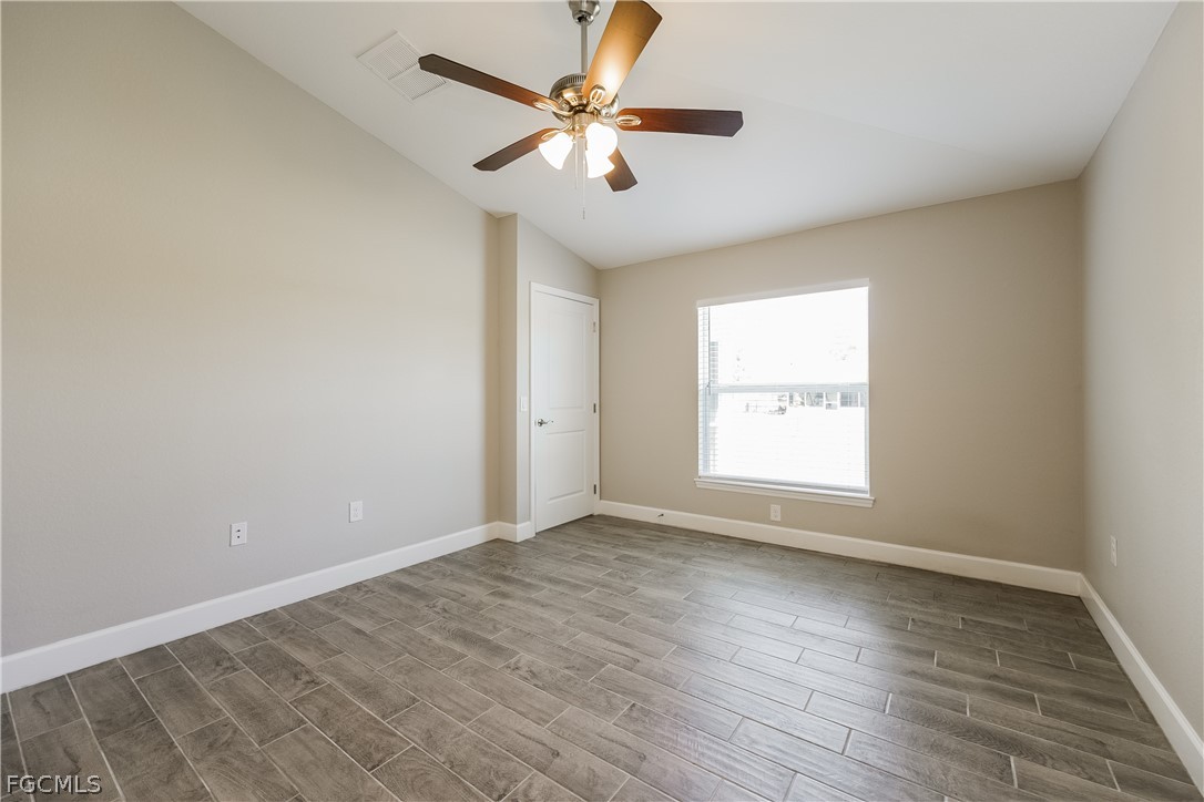 2900 7th Street West Lehigh Acres, FL 33971 - Photo 13 of 15 an empty room with wooden floor and windows