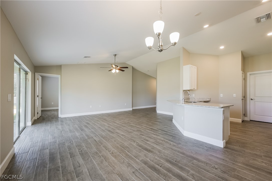 2900 7th Street West Lehigh Acres, FL 33971 - Photo 4 of 15 a view of a kitchen with a dishwasher wooden floor and a large window