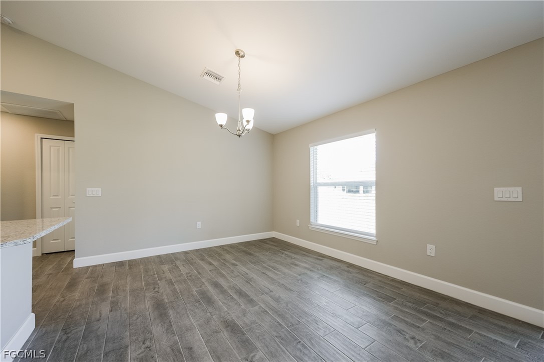 2900 7th Street West Lehigh Acres, FL 33971 - Photo 5 of 15 an empty room with wooden floor and windows