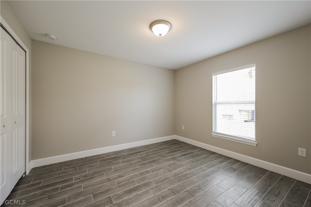 2900 7th Street West Lehigh Acres, FL 33971 - Photo 9 of 15 an empty room with wooden floor and windows