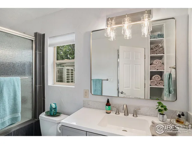 a bedroom with a bed and a potted plant