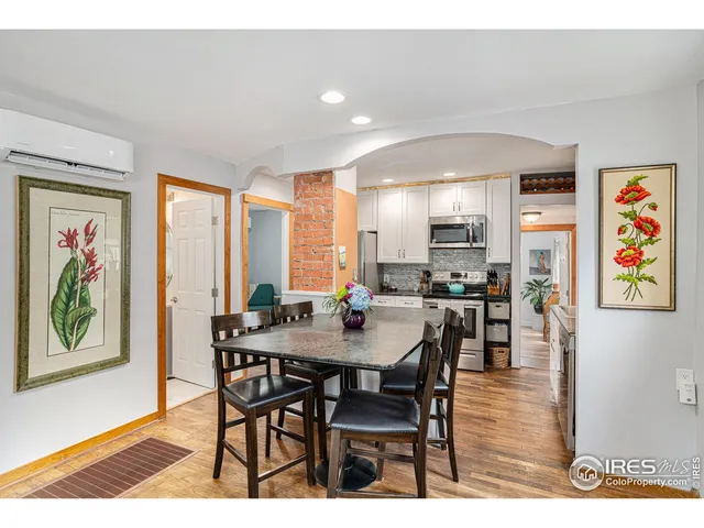 a view of a a dining room with furniture window and wooden floor