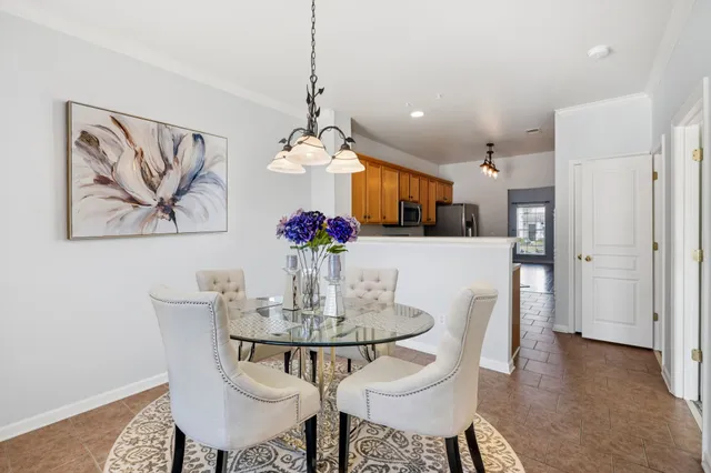 a view of a dining room with furniture and chandelier