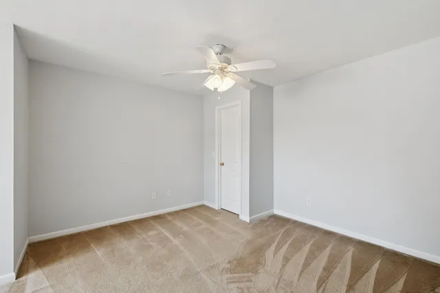 a view of a big room with chandelier fan