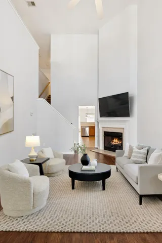 a living room with furniture a rug and a fireplace