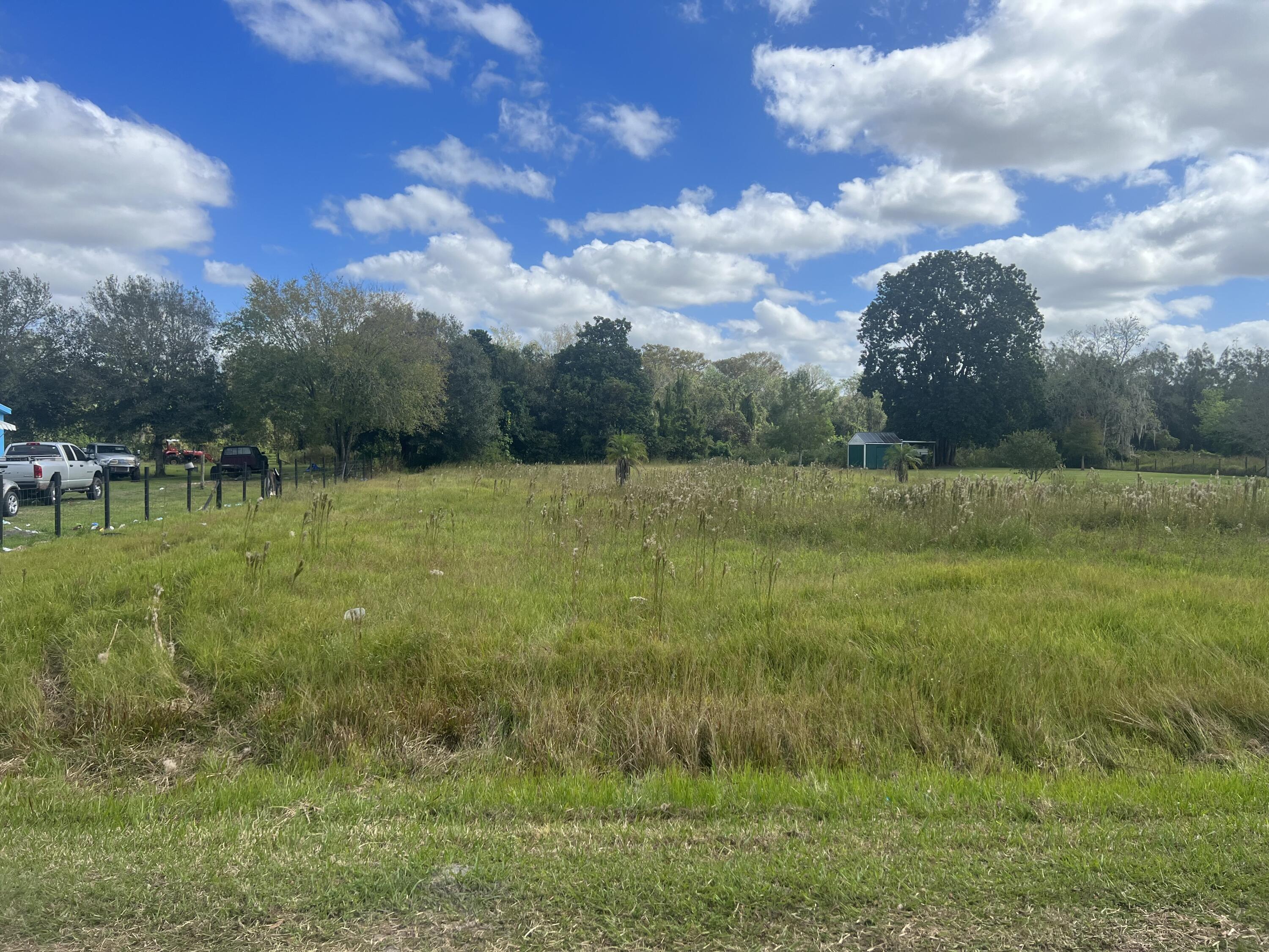 30910 Northeast 23rd Way Okeechobee, FL 34972 - Photo 4 of 8 a view of outdoor space with deck and yard