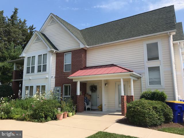 703 Canning House Row, Unit 902 Milton, DE 19968 - Photo 1 of 18 a front view of a house with garden