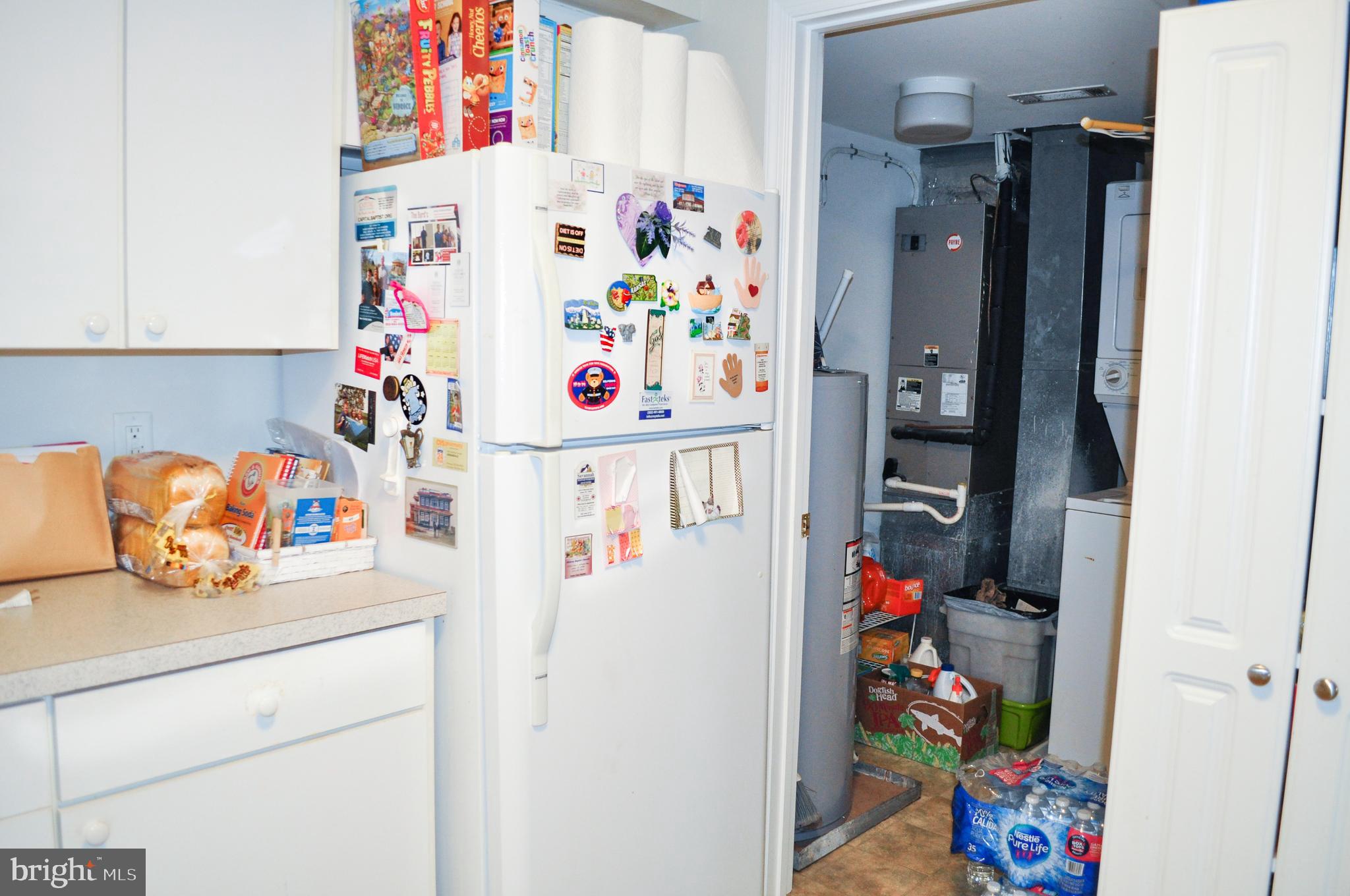 703 Canning House Row, Unit 902 Milton, DE 19968 - Photo 4 of 18 a white refrigerator freezer sitting inside of a kitchen