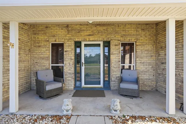 a view of entryway with couch and chairs