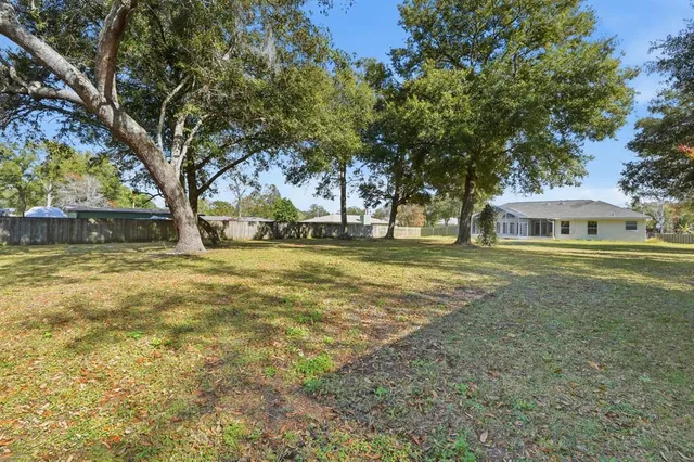 a house view with swimming pool in front of it
