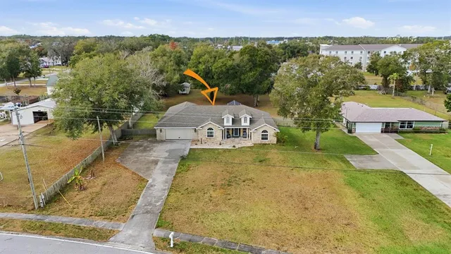 an aerial view of a house with a yard