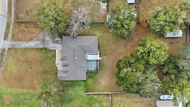 an aerial view of a house with a yard