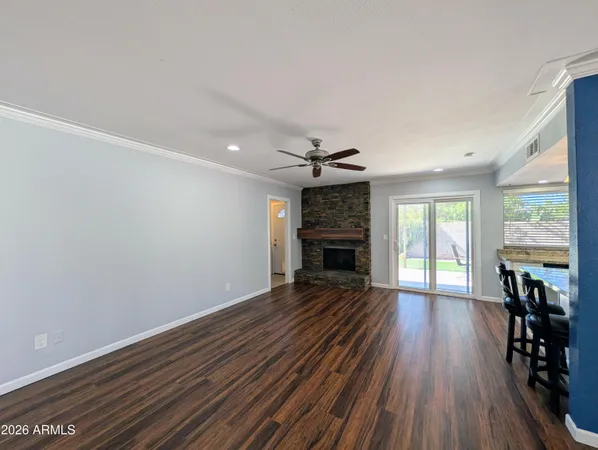 a view of a hallway with wooden floor and closet