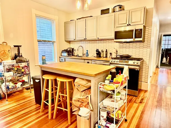 a kitchen with stainless steel appliances kitchen island granite countertop a sink and cabinets