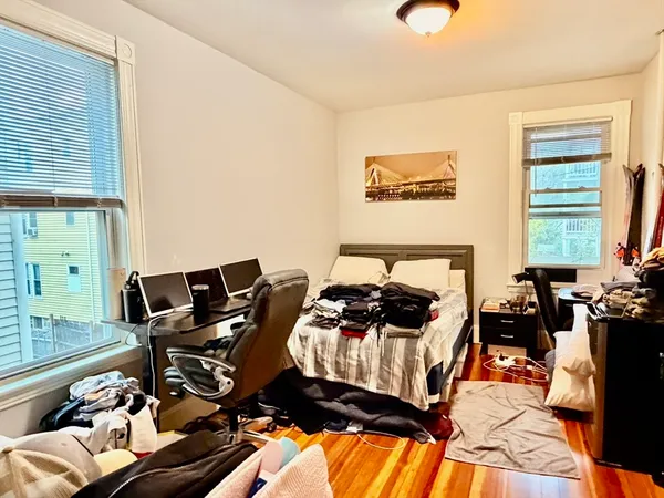 a bedroom with furniture and a window