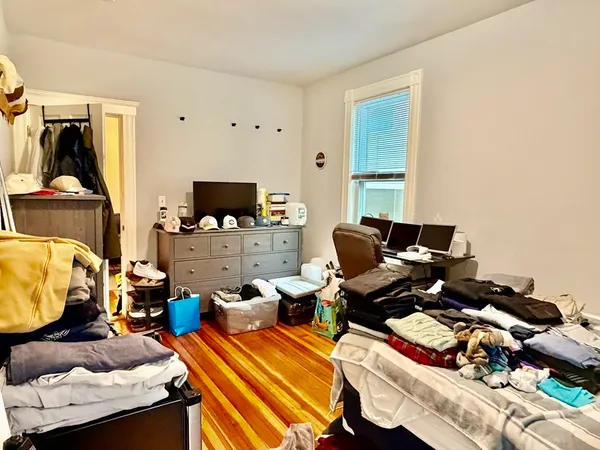 a bedroom with furniture and a flat screen tv