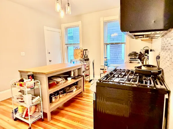 a kitchen with stainless steel appliances granite countertop a stove and a sink