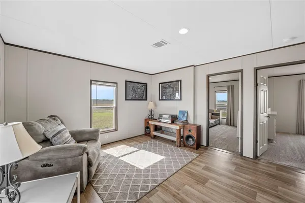 a living room with furniture and wooden floor