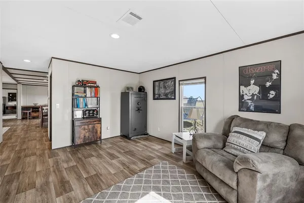 a living room with furniture and wooden floor