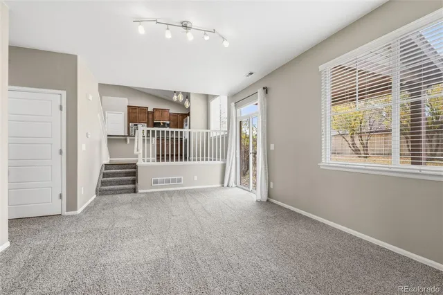 an empty room with windows and closet