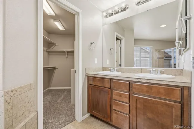a bathroom with a double vanity sink and a mirror