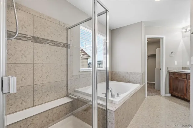 a bathroom with a tub and shower