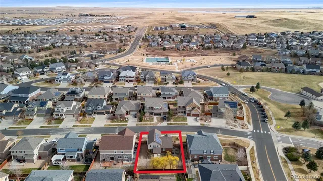 a view of a house with wooden fence and large windows
