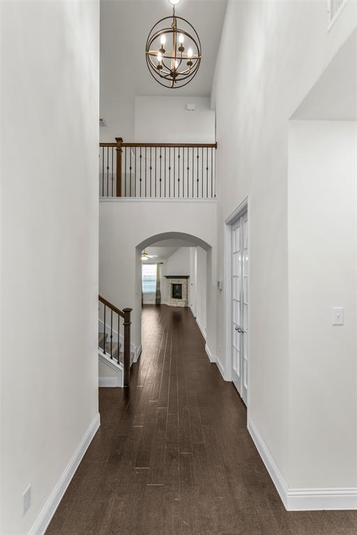 15713 Canyon Ridge Prosper, TX 75078 - Photo 5 of 38 foyer featuring dark wood-finish flooring, a contemporary spherical chandelier, and white walls with contrasting baseboards