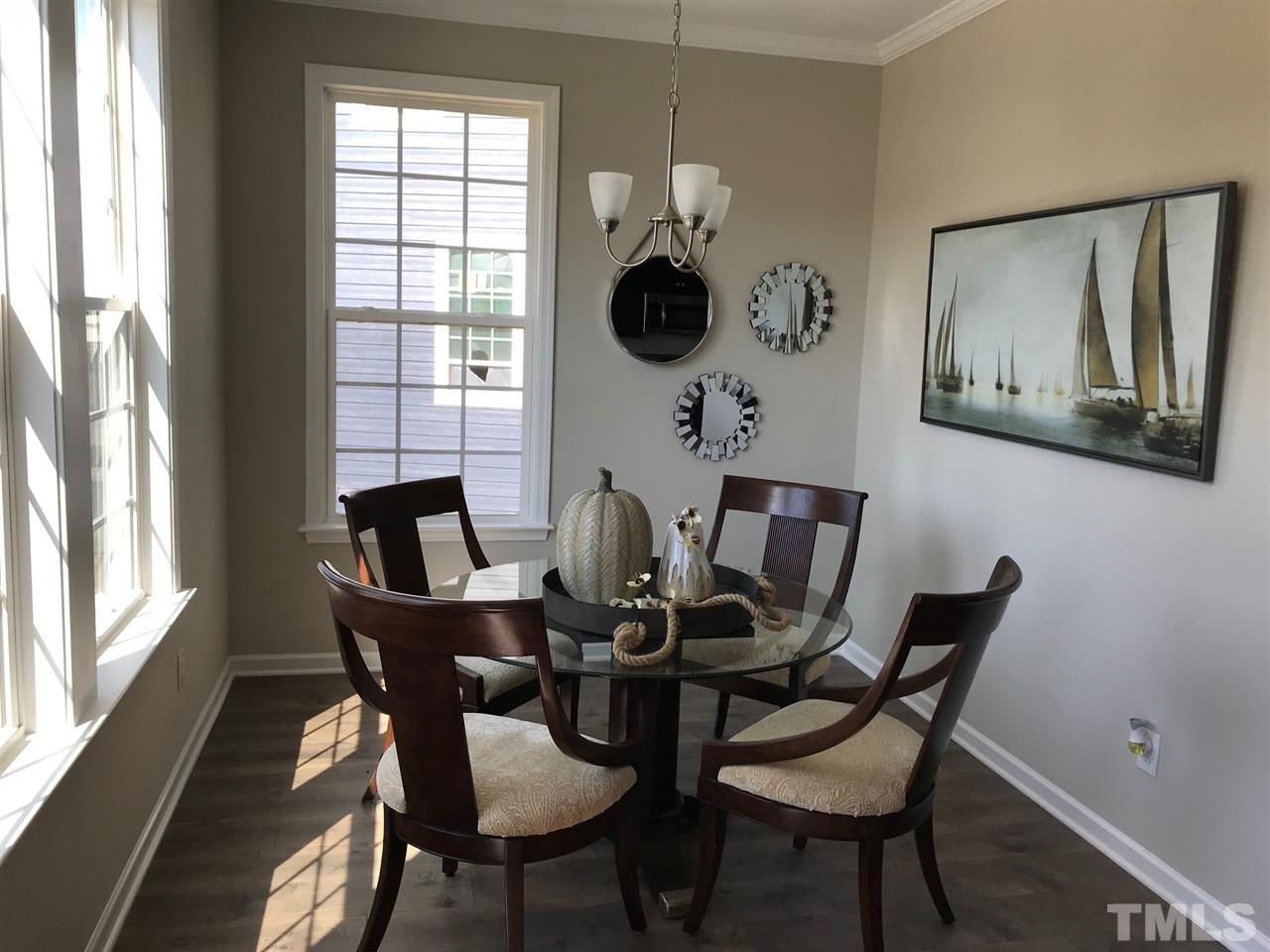 6419 Perry Creek Road Raleigh, NC 27616 - Photo 2 of 7 a dining room with furniture and chandelier