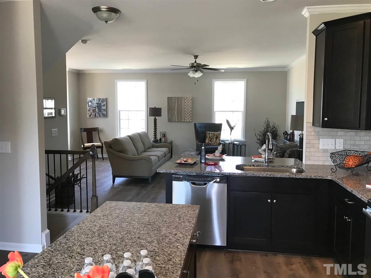 6419 Perry Creek Road Raleigh, NC 27616 - Photo 3 of 7 a living room with a couch and a chandelier