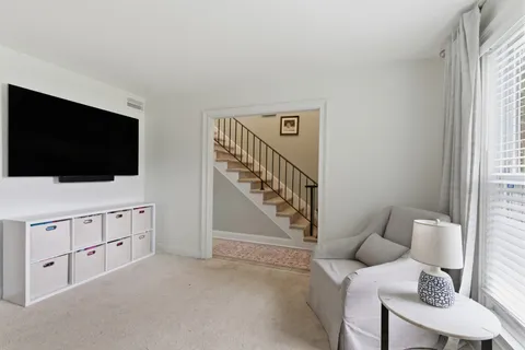 a living room with furniture and flat screen tv