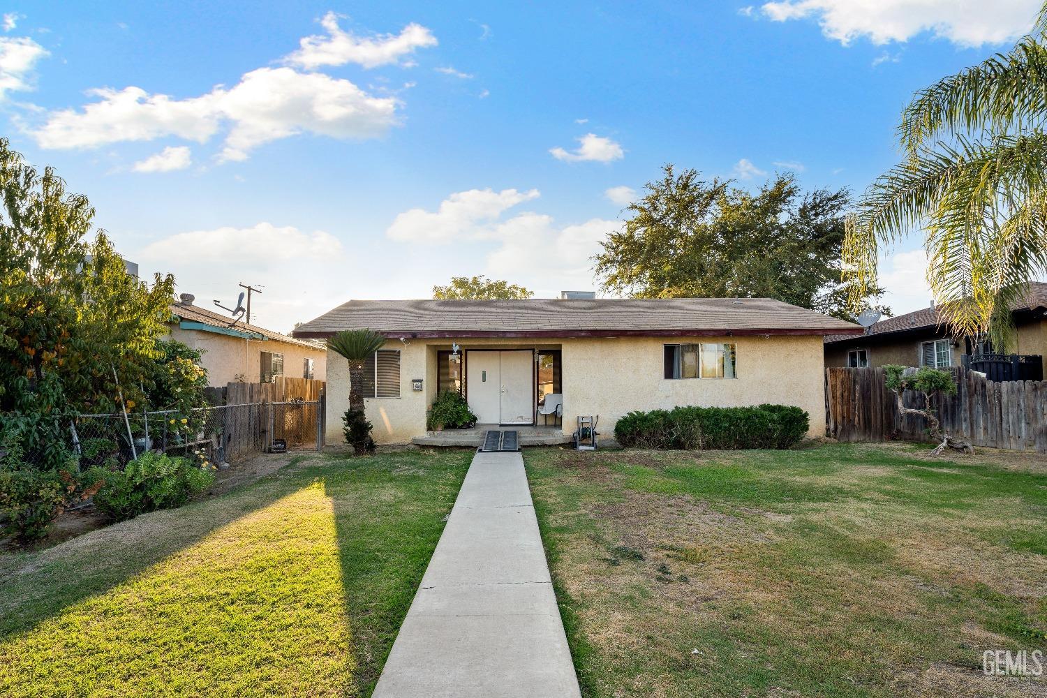 Undisclosed Address Delano, CA 93215 - Photo 2 of 10 a front view of house with yard and trees