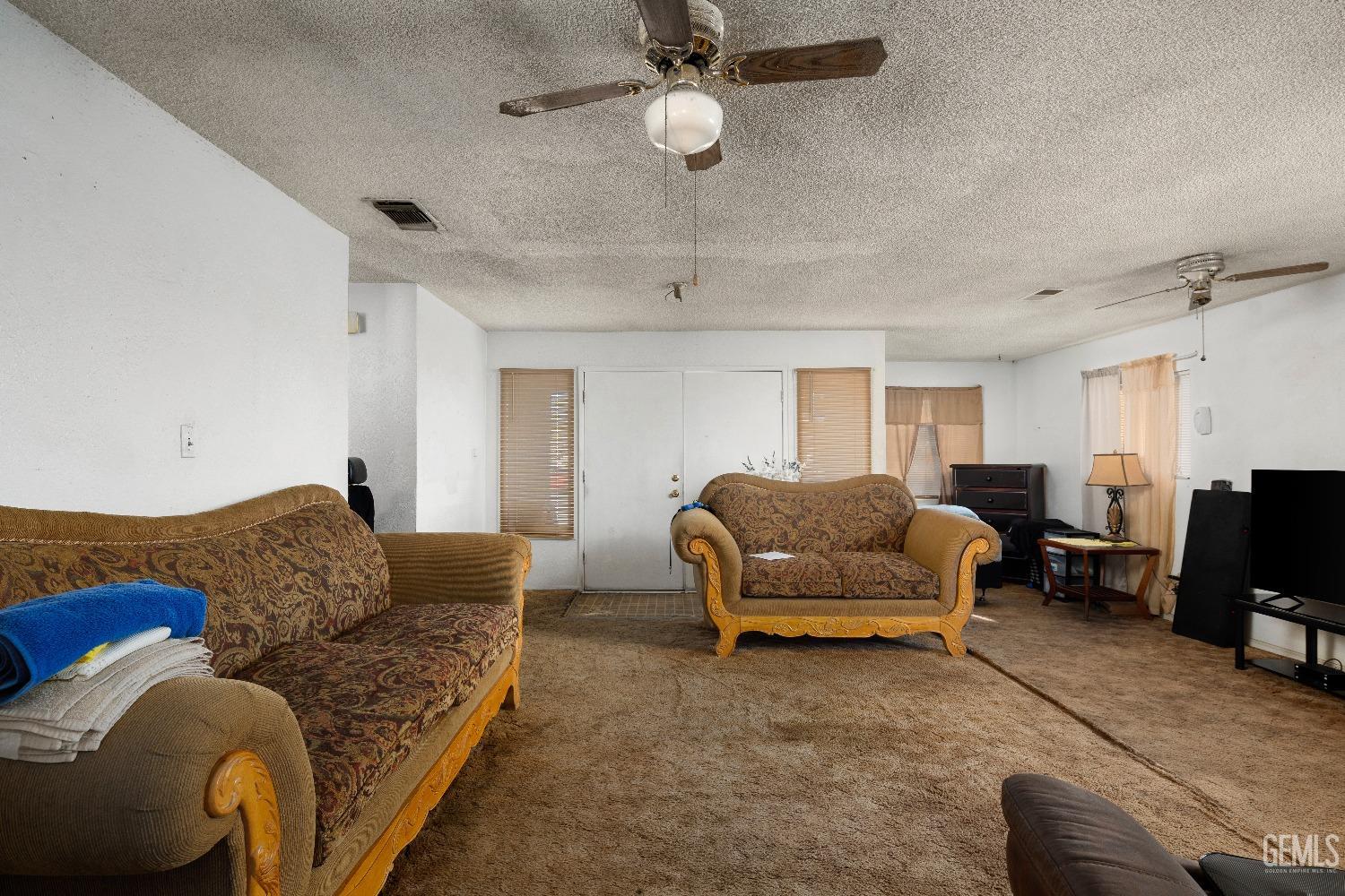 Undisclosed Address Delano, CA 93215 - Photo 5 of 10 a living room with furniture and a chandelier