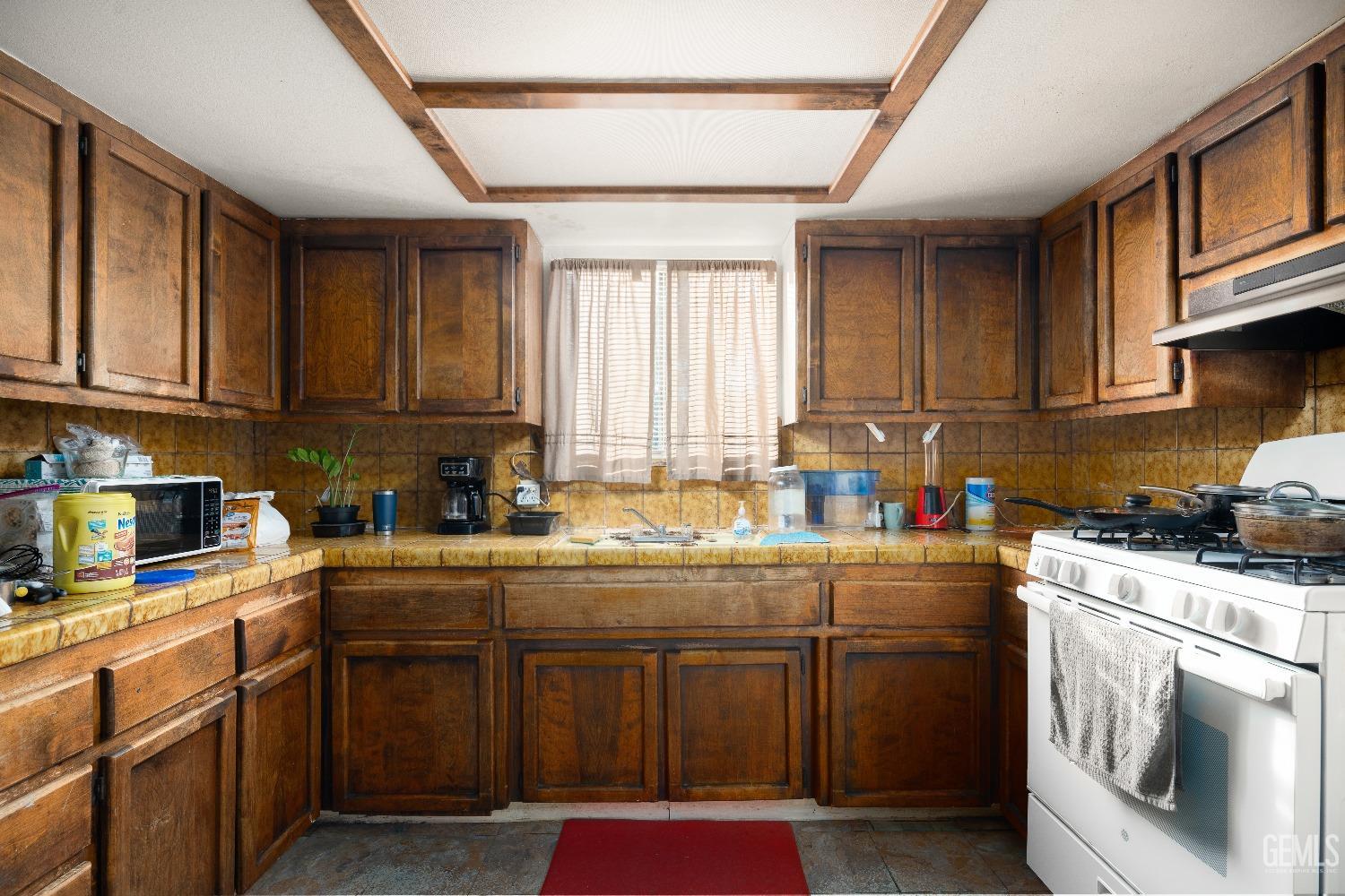 Undisclosed Address Delano, CA 93215 - Photo 7 of 10 a kitchen with stainless steel appliances granite countertop a stove a sink dishwasher and a refrigerator