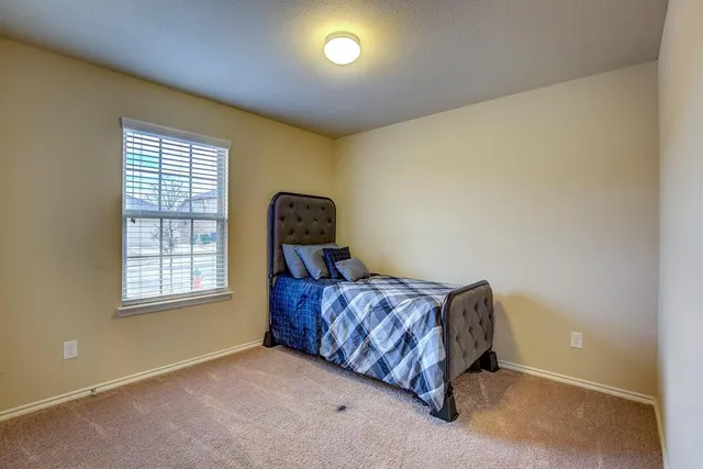 a bed sitting in a room next to a window