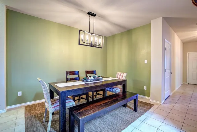 a view of a dining room with a table and chairs