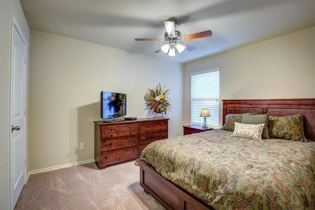 a bedroom with a large bed and a chandelier